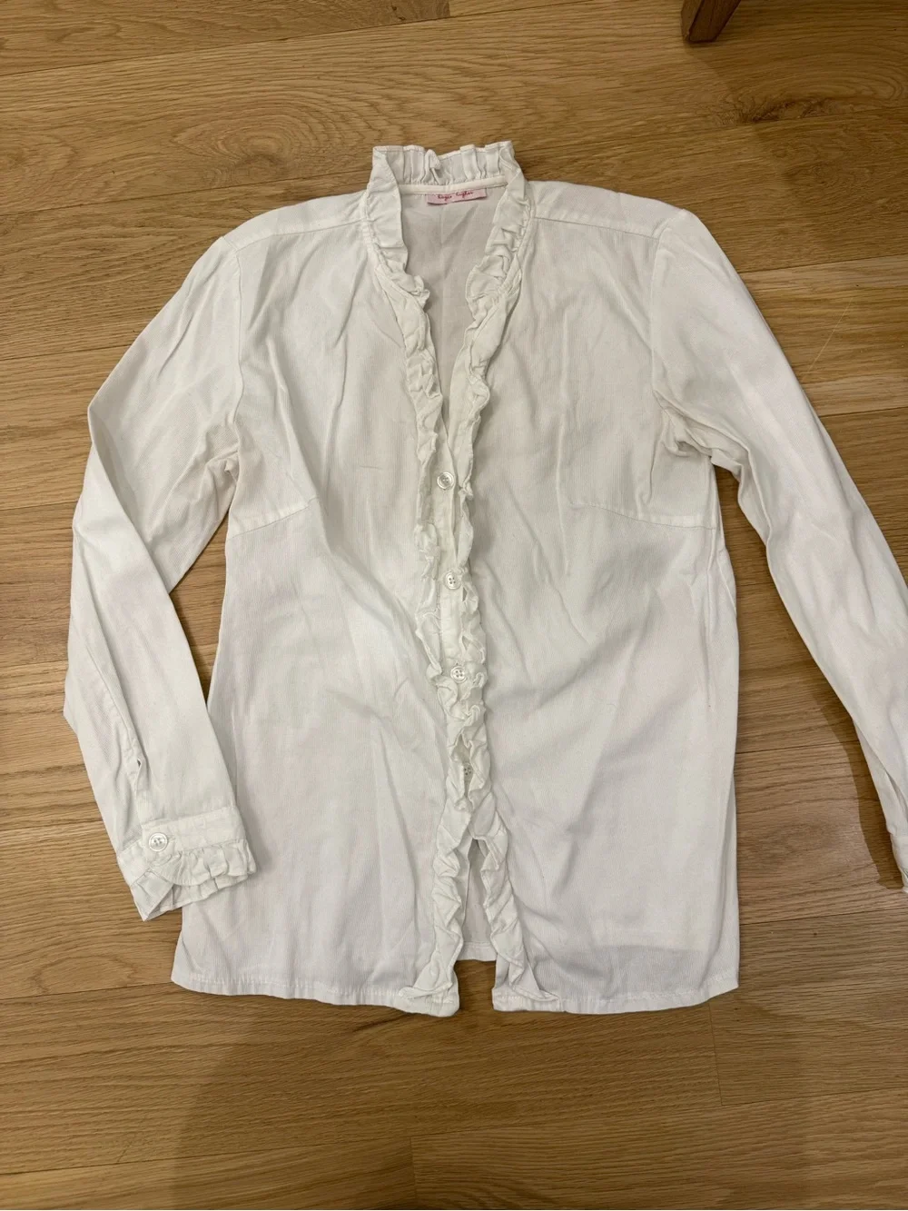 Kayce Hughes white long sleeve ruffle blouse